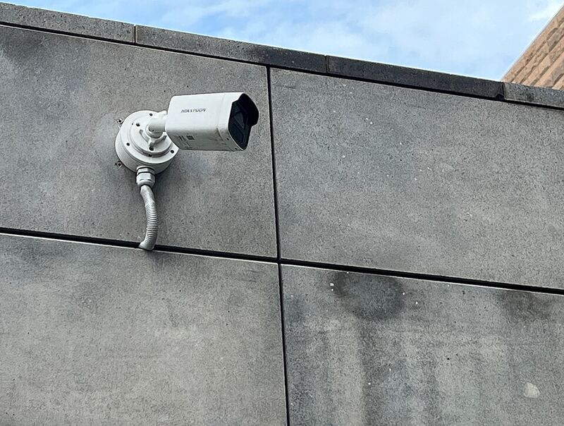 Hikvision bullet CCTV camera installed on an exterior wall with neat conduit cabling